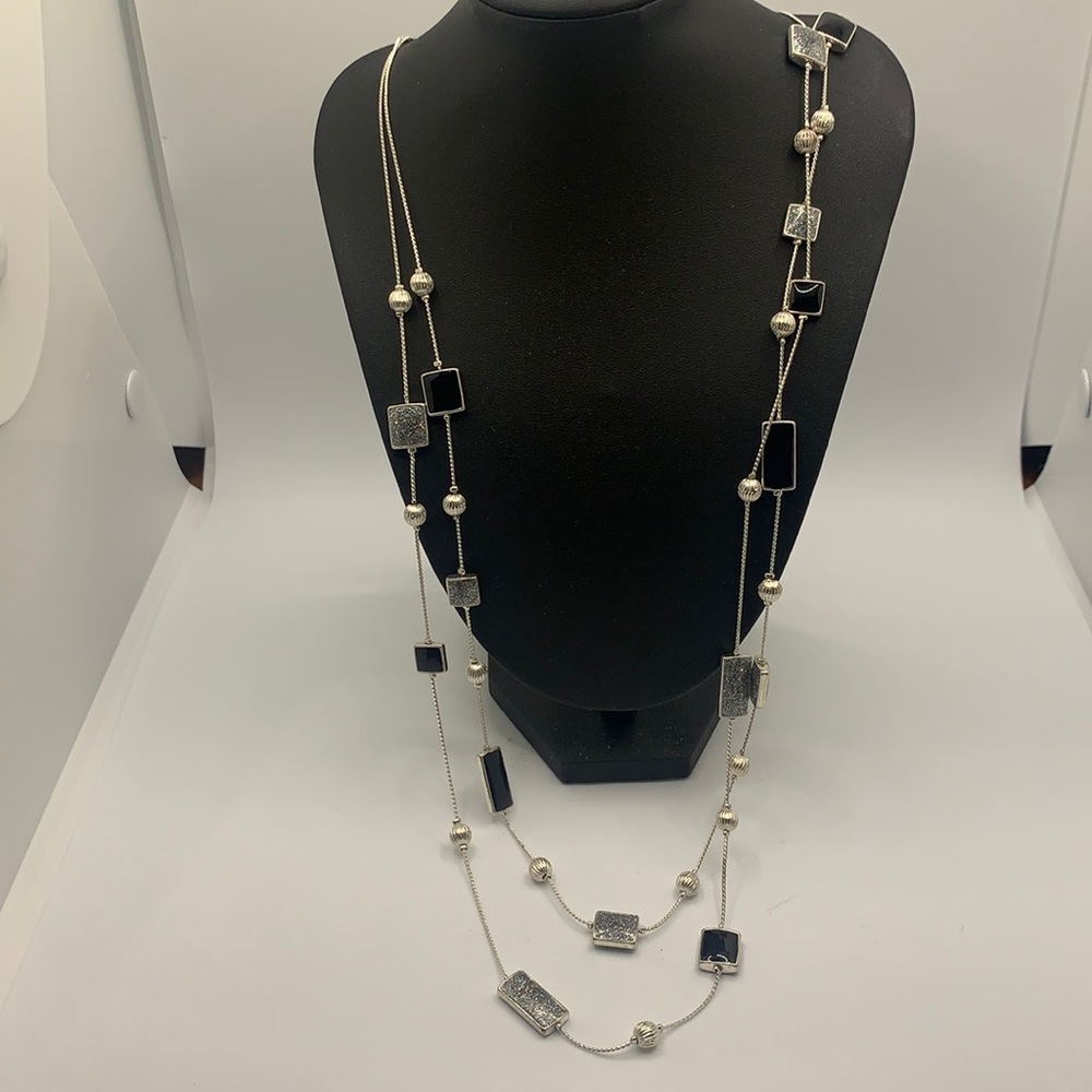 Woman’s silver and black necklace